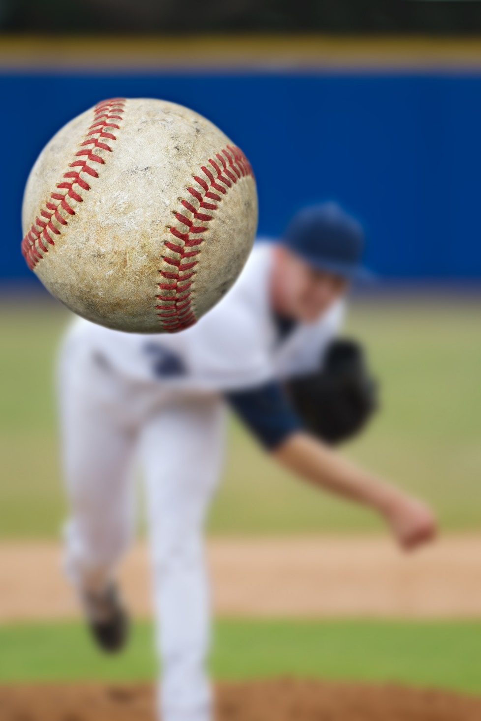 A baseball player throwing a baseball

Description automatically generated