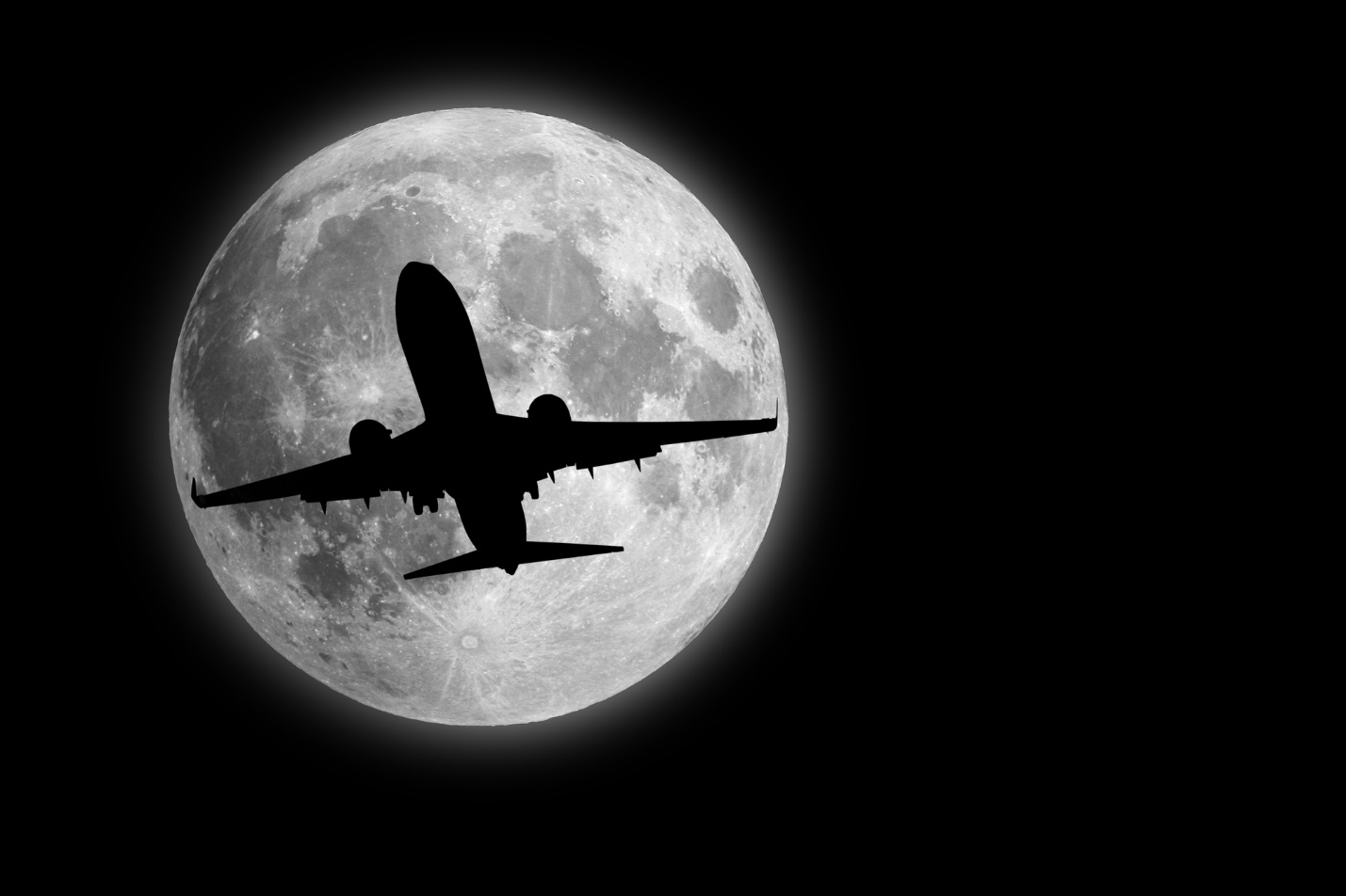 A plane flying in front of the moon

Description automatically generated with medium confidence