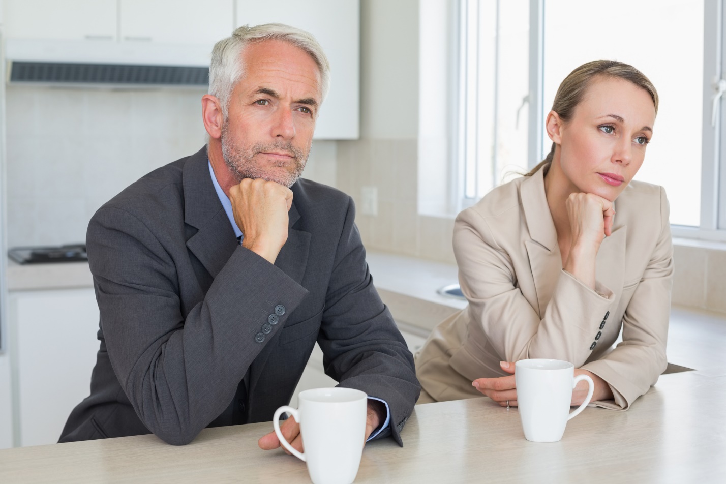 Two people sitting at a table with coffee cups

Description automatically generated with medium confidence