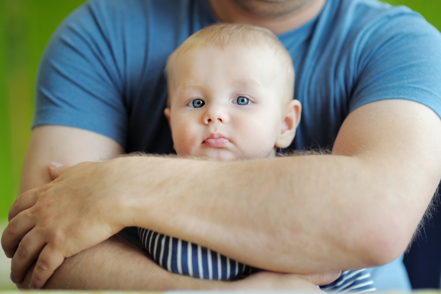 A baby being held by a person

Description automatically generated with medium confidence