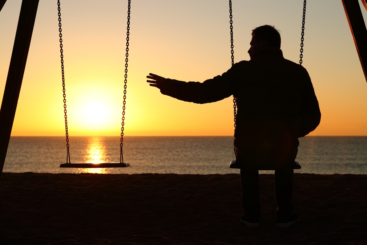 A person sitting on a swing at sunset

Description automatically generated with medium confidence