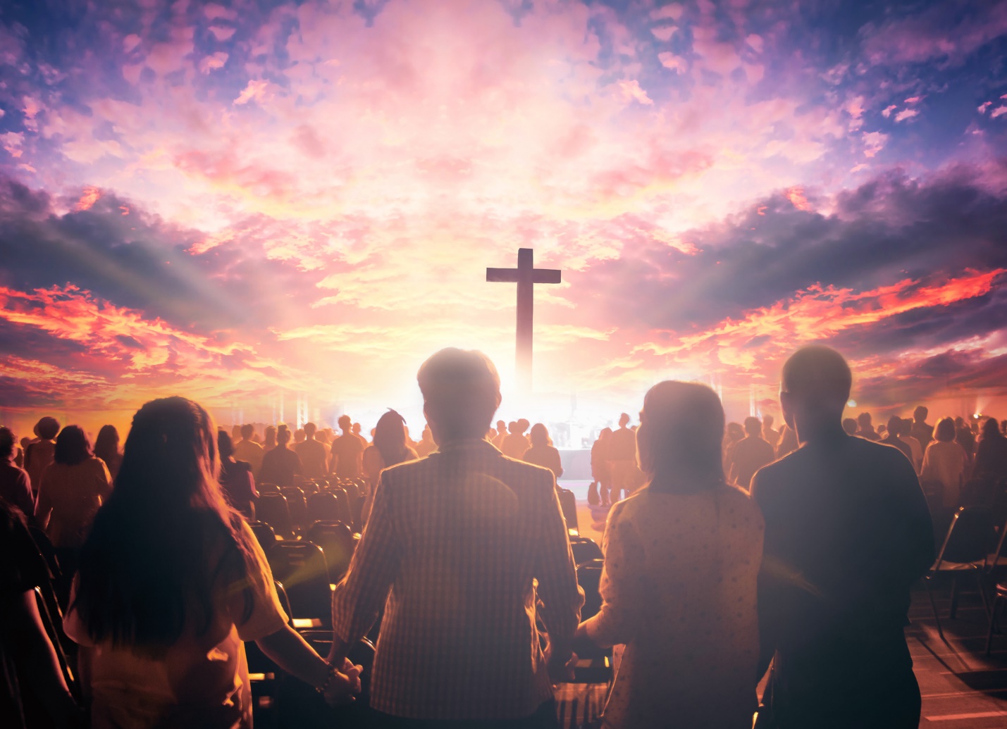 A group of people standing in front of a cross on a hill

Description automatically generated with low confidence