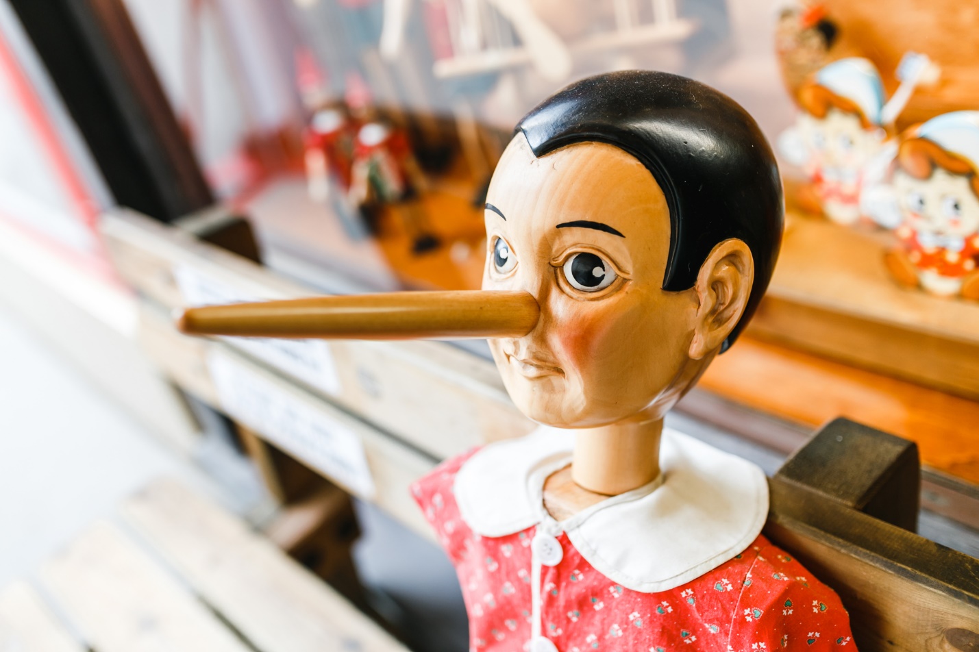 A wooden pinocchio doll with long nose

Description automatically generated