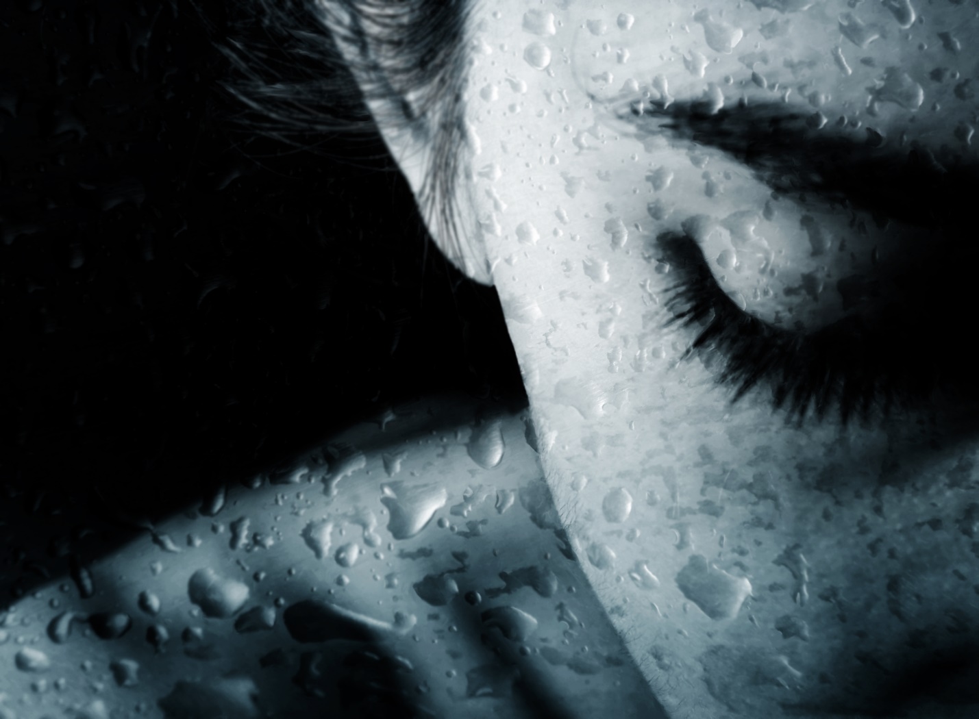 Close-up of a person's face with water drops on her face

Description automatically generated