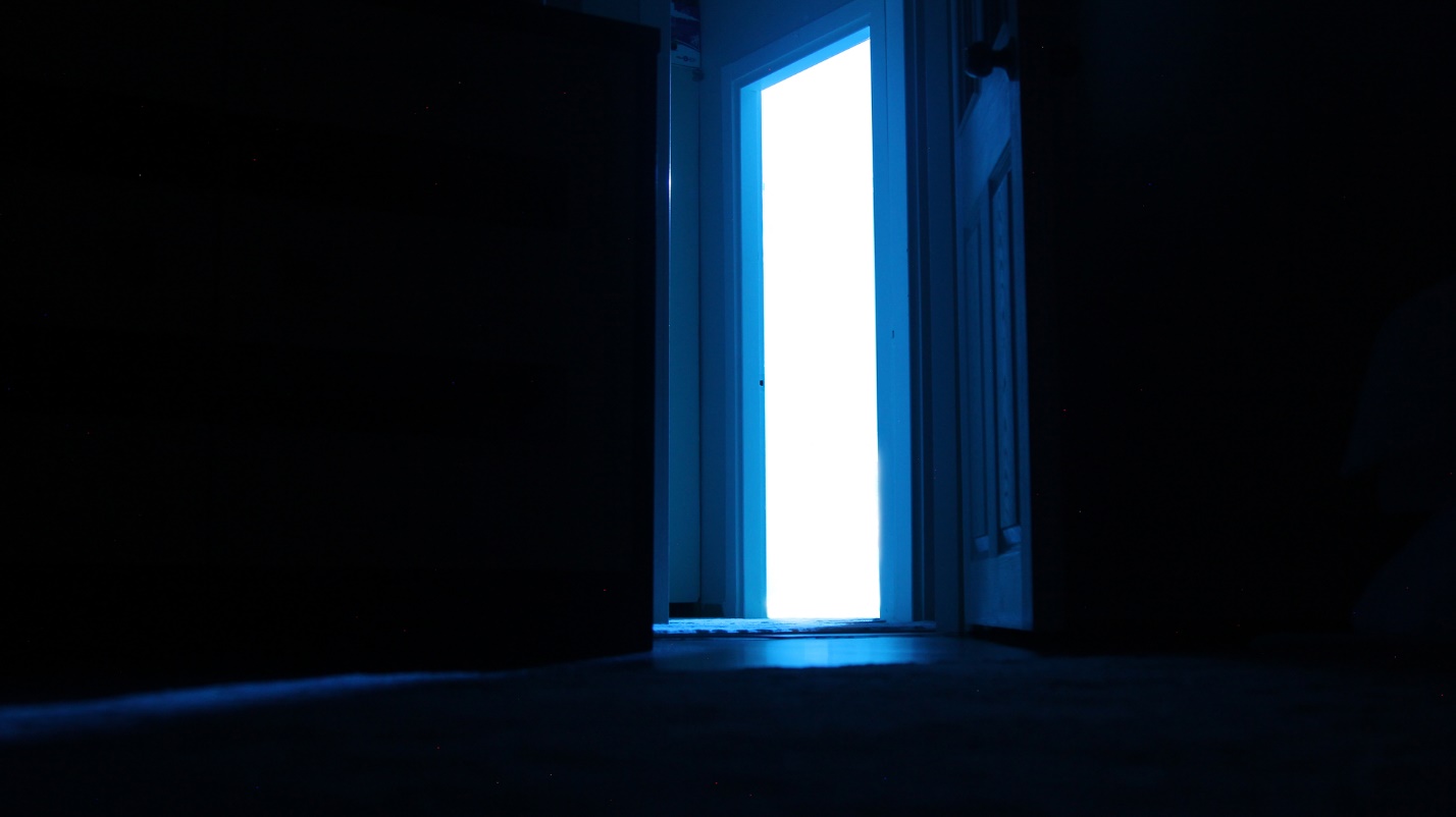 A light coming through a door

Description automatically generated