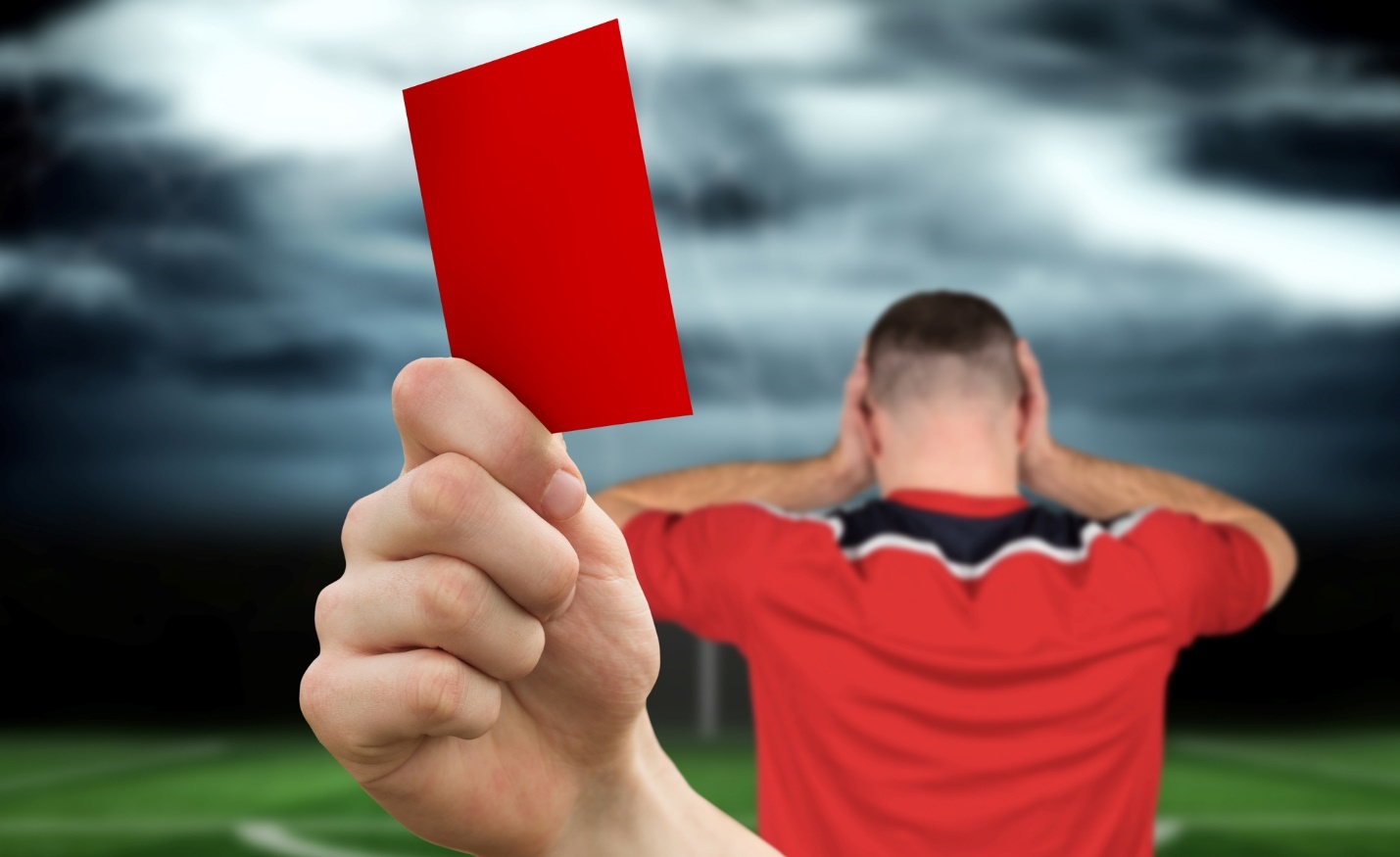 A person holding a red card

Description automatically generated