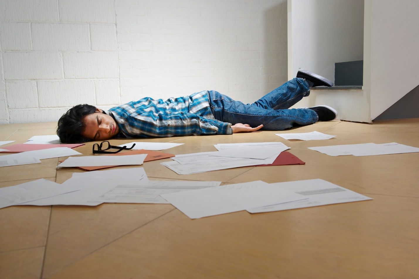 A person lying on the floor with his eyes closed

Description automatically generated
