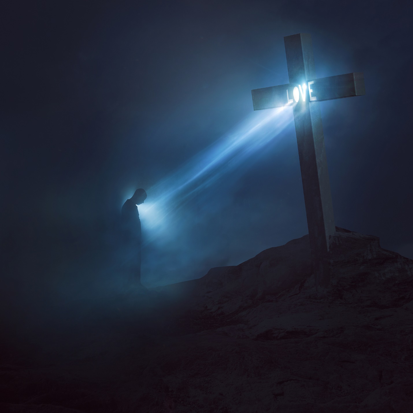 A person standing in front of a cross with a light shining on it

Description automatically generated