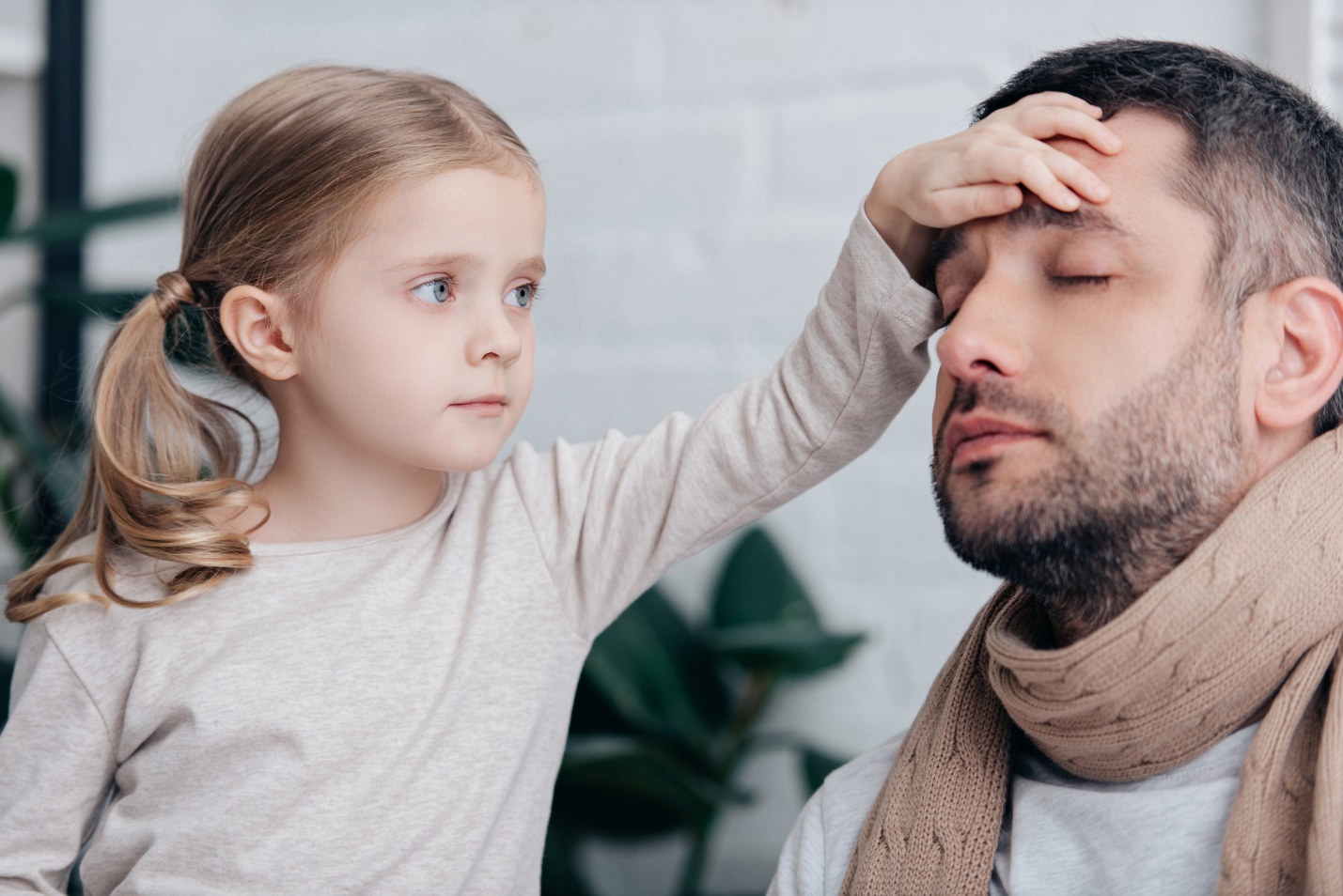 A child touching a person's forehead

Description automatically generated