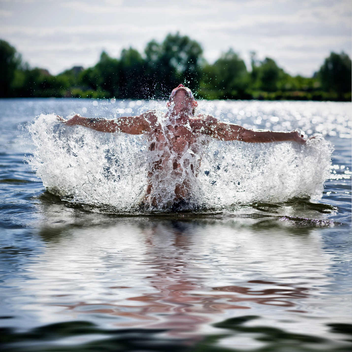 A person splashing water in the water

Description automatically generated