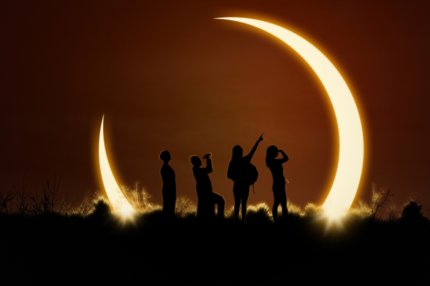 A group of people standing in front of a moon

Description automatically generated