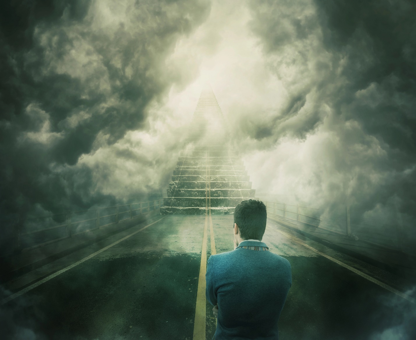 A person standing on a road with stairs leading to the sky

Description automatically generated