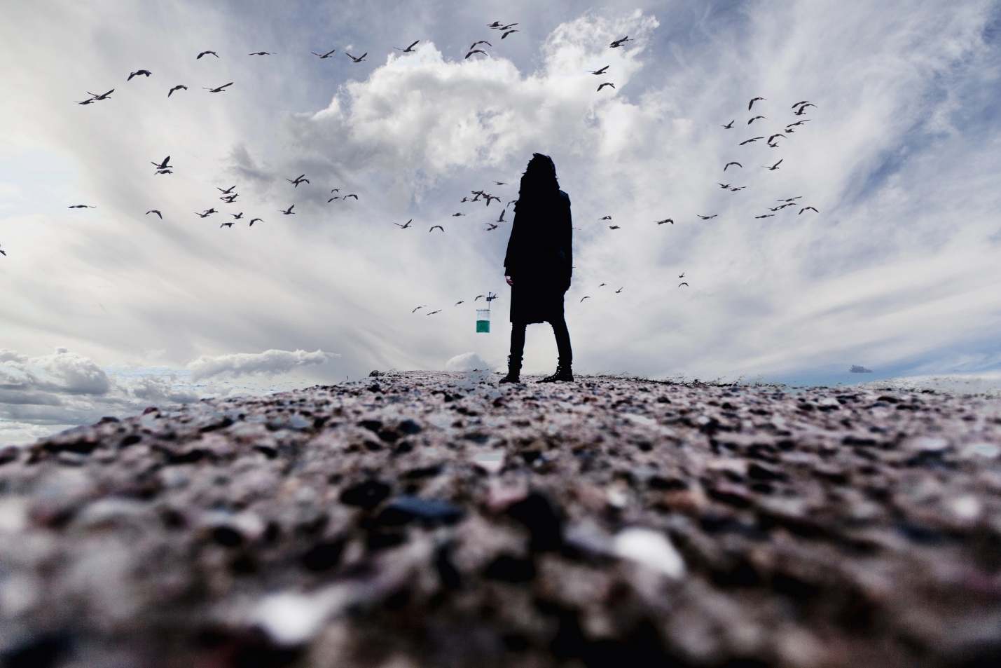 A person standing on a rocky surface

Description automatically generated