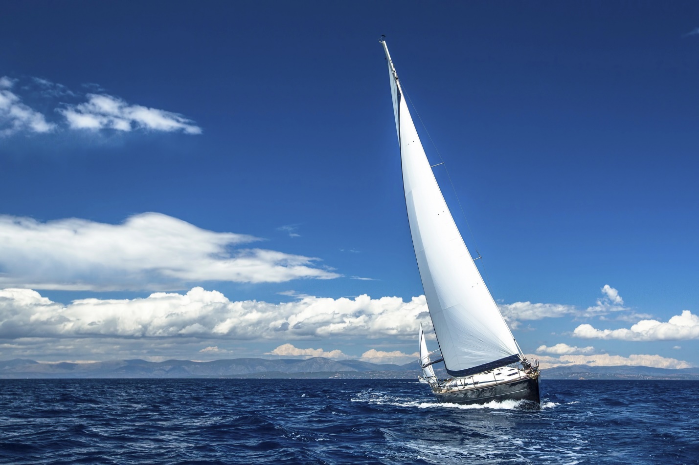 A sailboat in the ocean

Description automatically generated