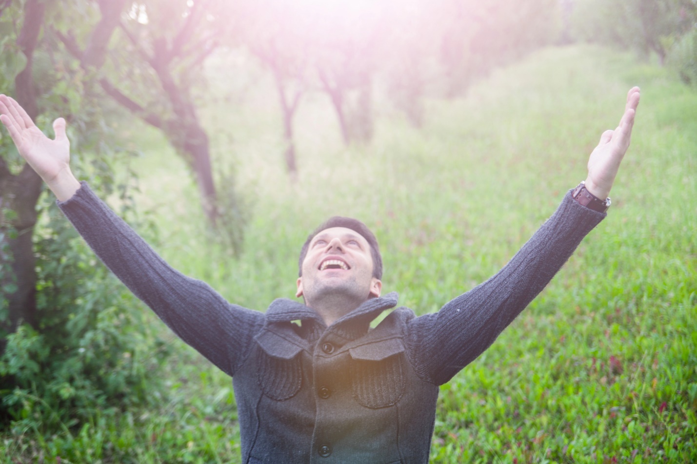 A person with his arms up in the air

Description automatically generated