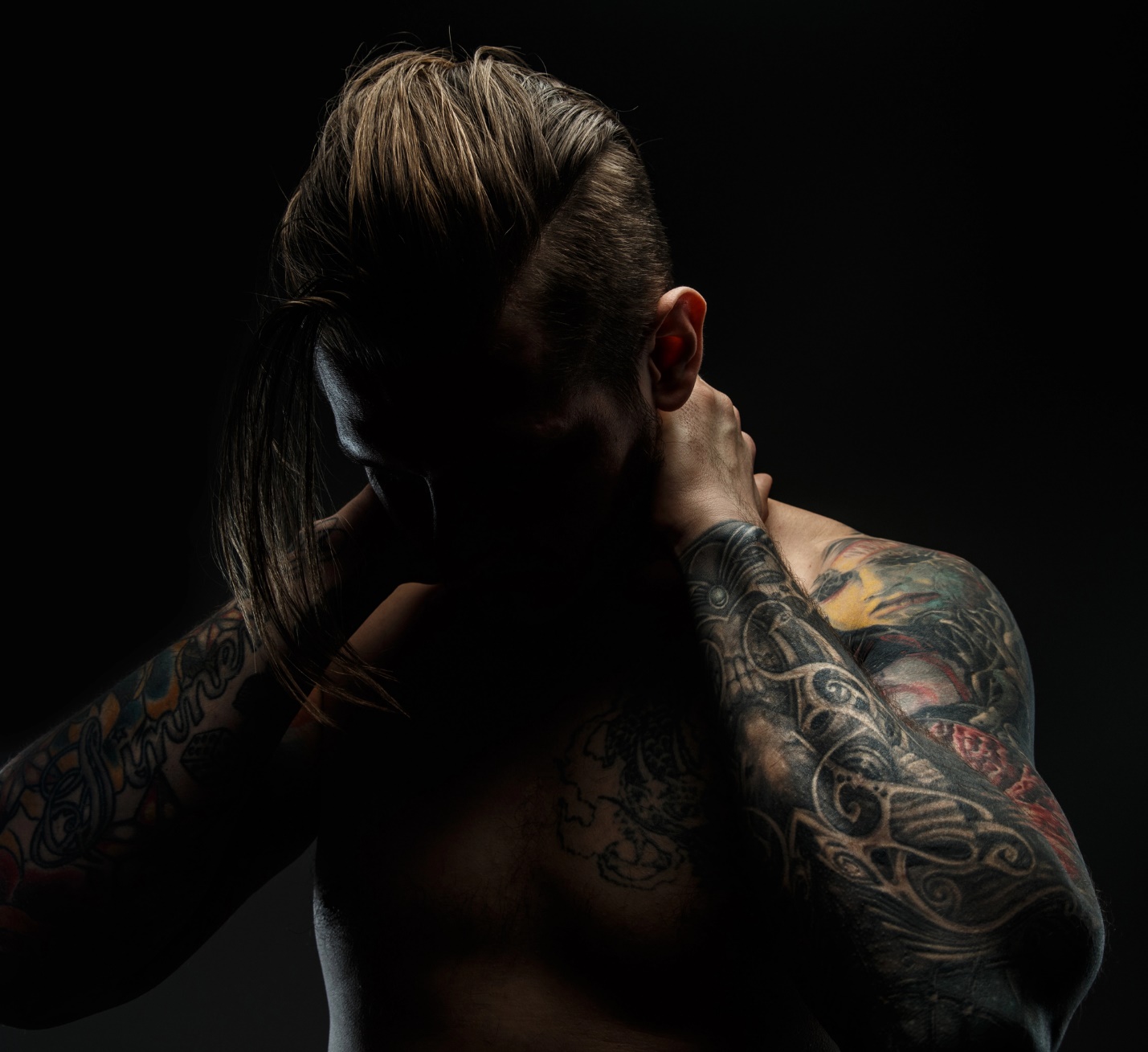 A person with tattoos on his face

Description automatically generated