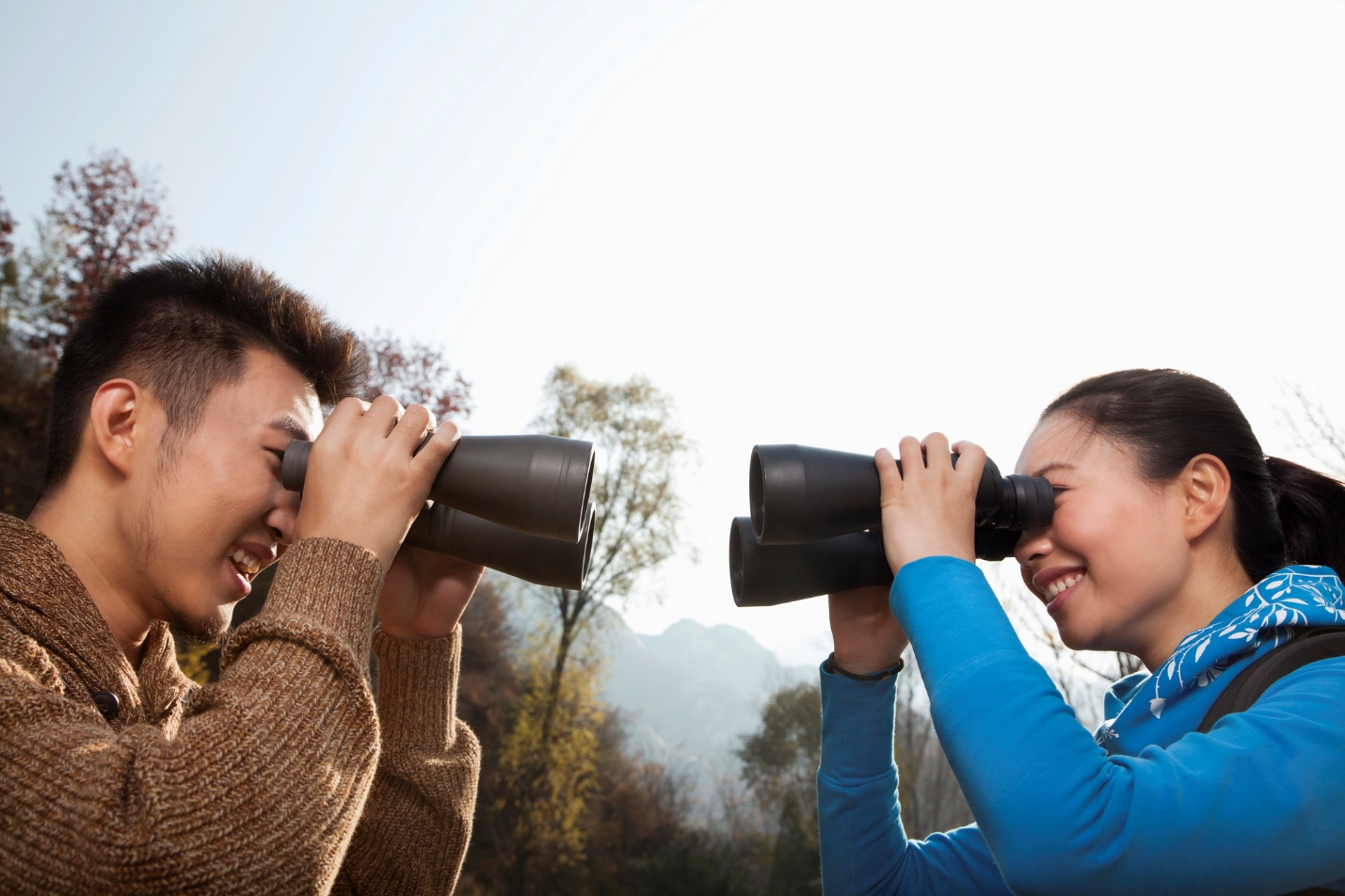 A person and person looking through binoculars

Description automatically generated