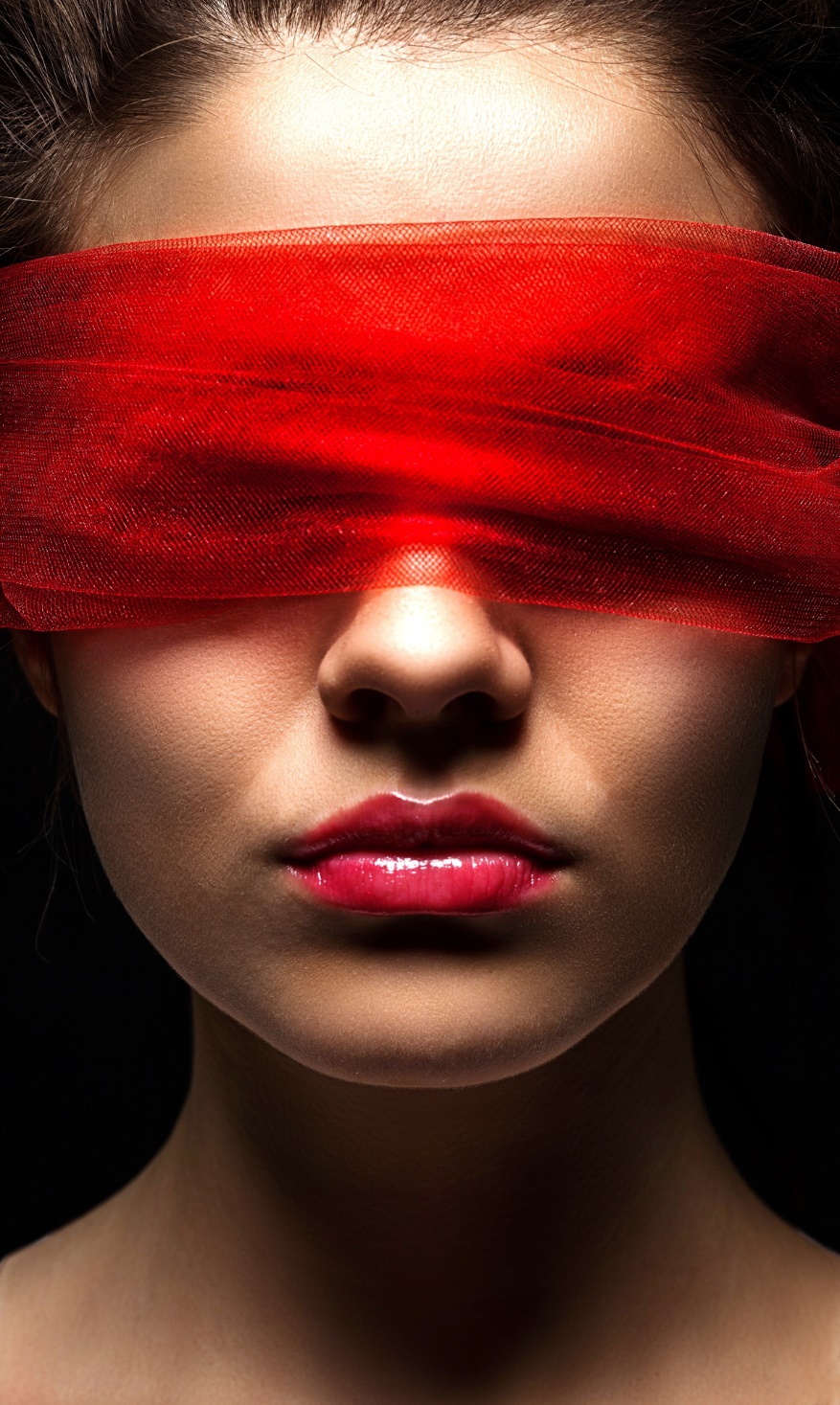 A person with red fabric covering her eyes

Description automatically generated