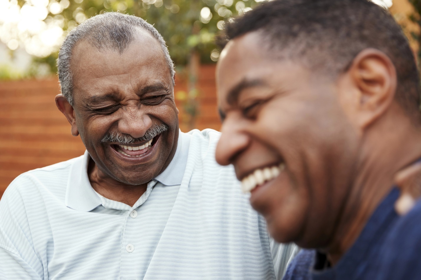 Medium shot of men laughing

Description automatically generated