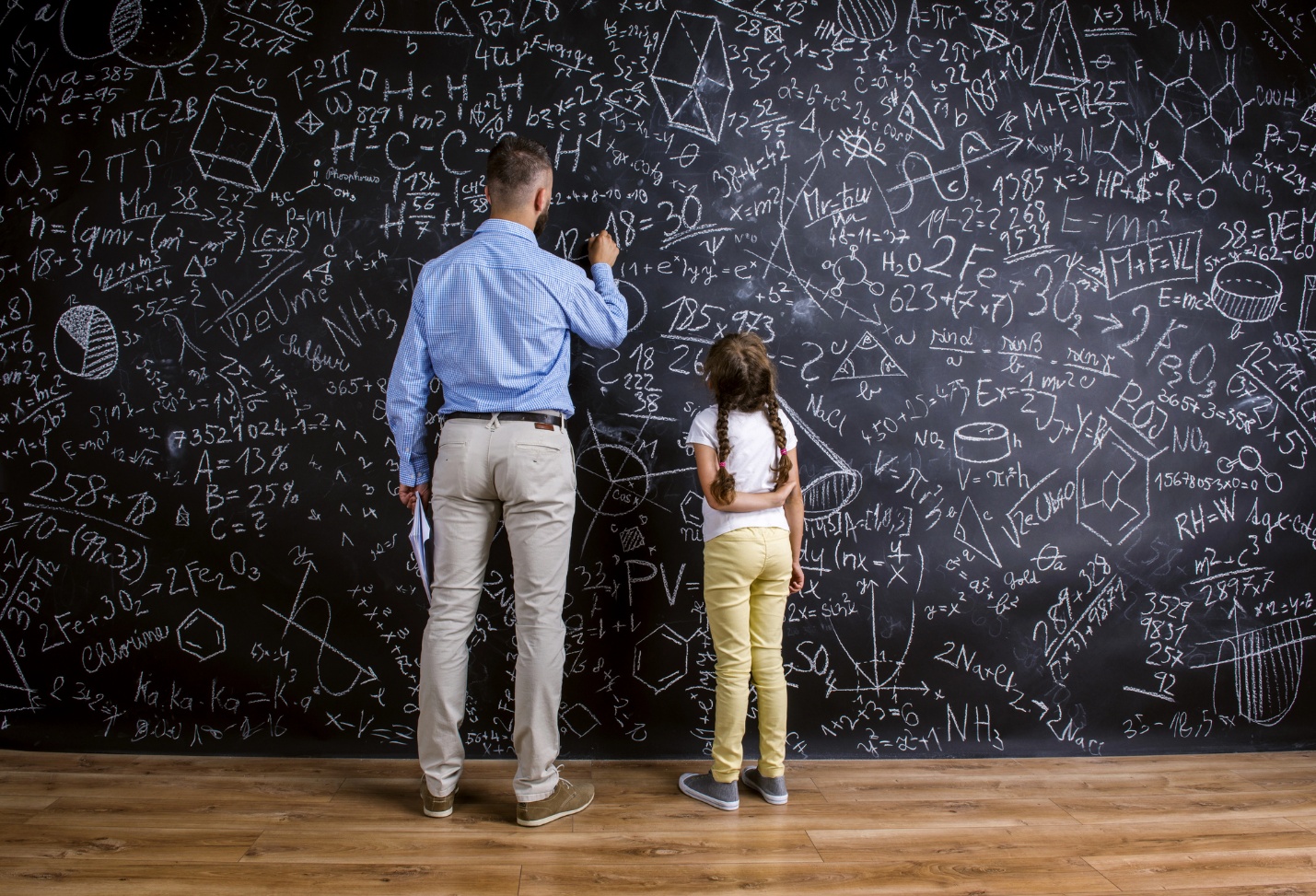 A person and child writing on a blackboard

AI-generated content may be incorrect.