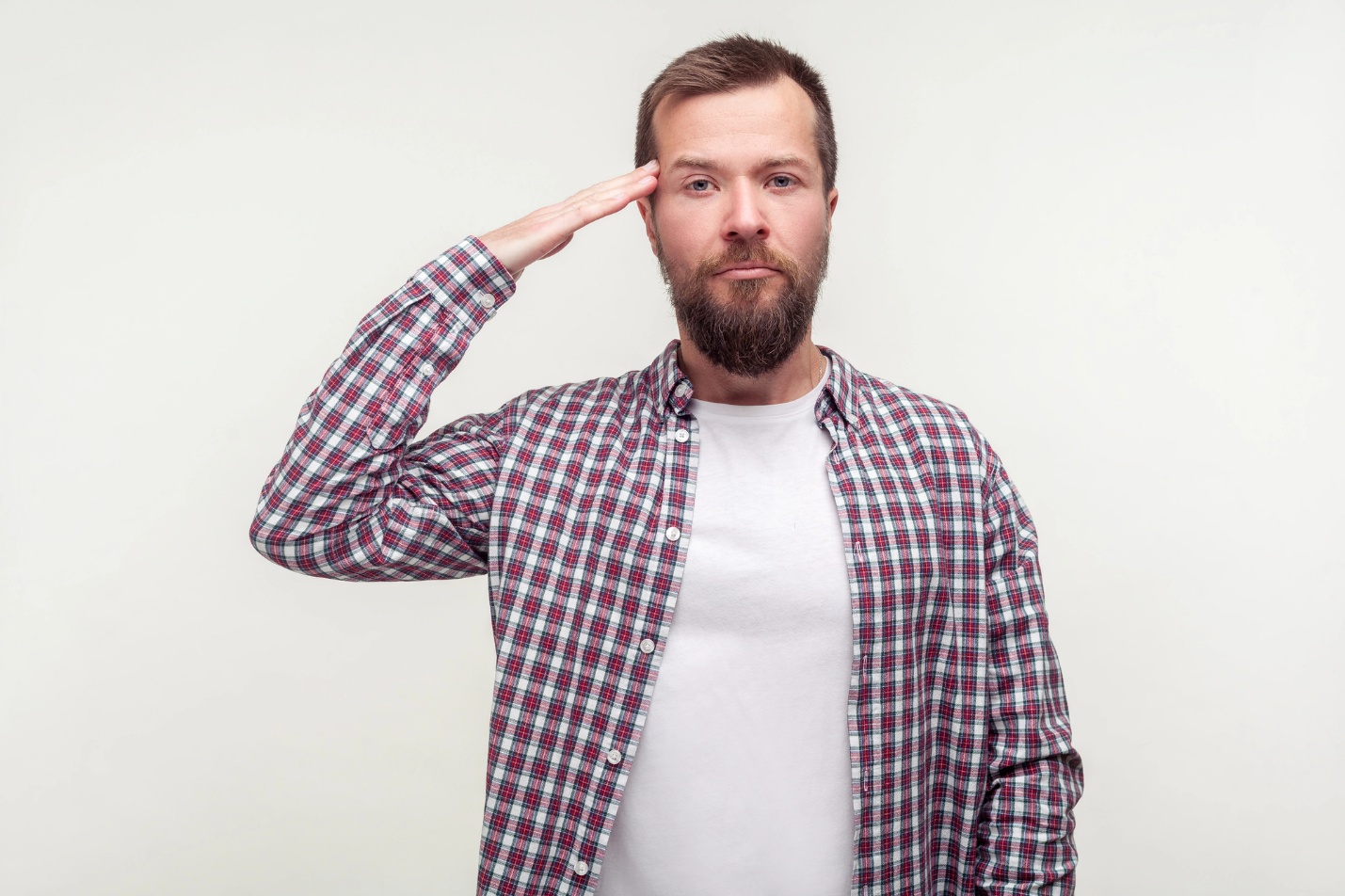 A person with beard saluting

Description automatically generated